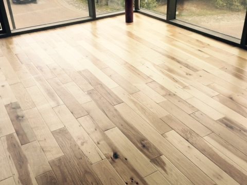 Wide-plank hickory flooring in a bright open room